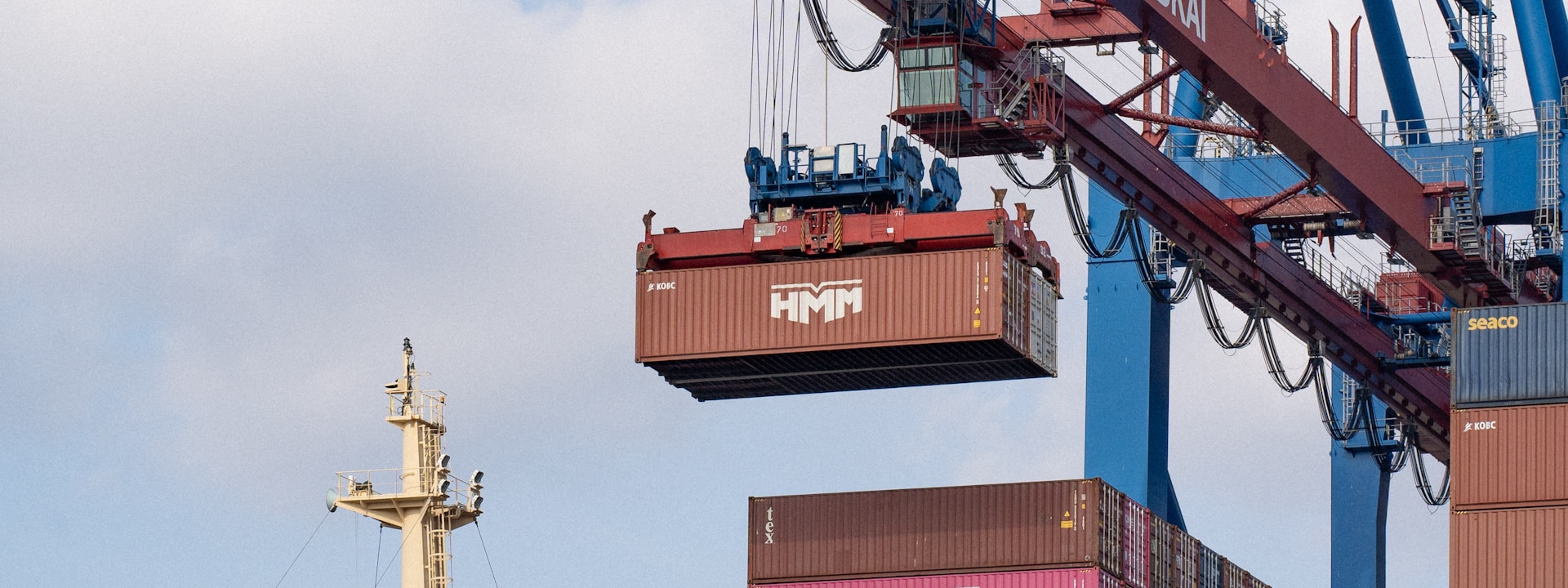 Crane loading shipping containers onto cargo vessel